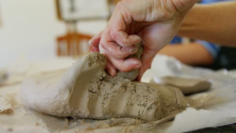 close-up of artist molding clay at table 4k