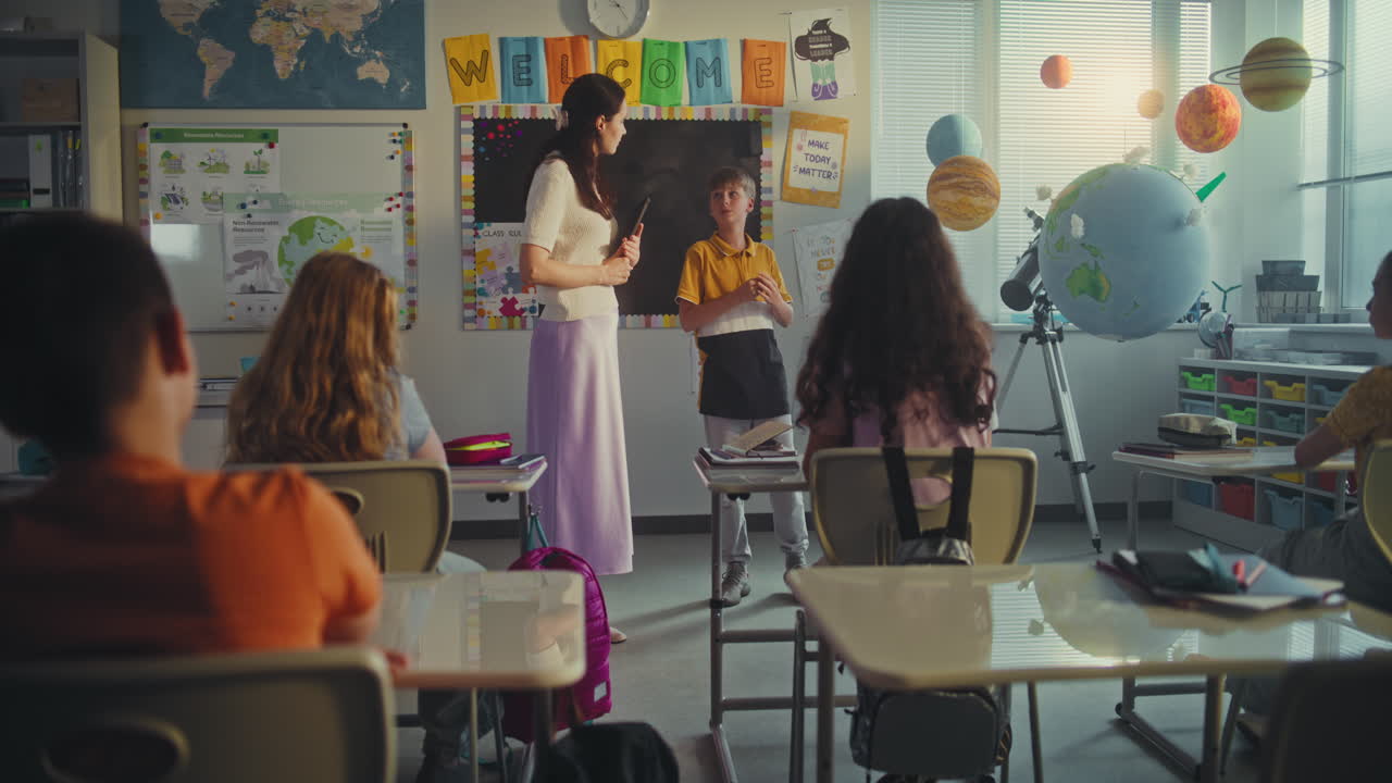 Primary School Boy Presenting Homework on Renewable Energy Resources in Front of Class