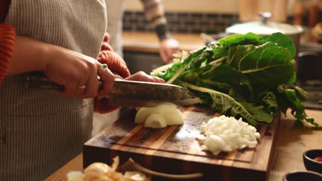 woman chopping vegetables in kitchen