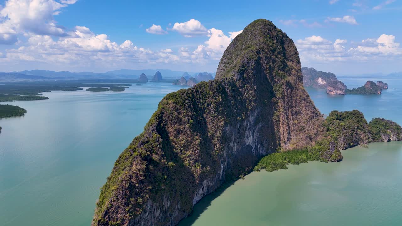 las imágenes de drones capturan los impresionantes acantilados de piedra caliza y las aguas turquesas de la bahía de phang nga, tailandia, a la luz del día.