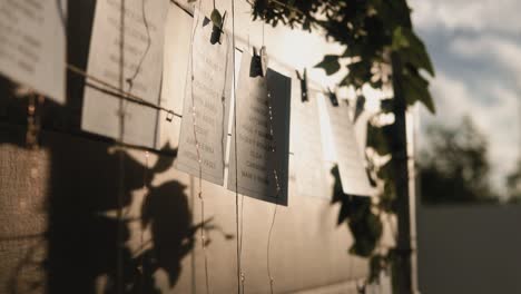 scenic shot of quotes hanging on clothing pins in the sunlight outdoors at wedding event