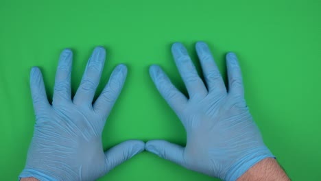 hands in medical gloves move across an abstract screen. operating the device in compliance with hygienic standards. upper view, chroma key.