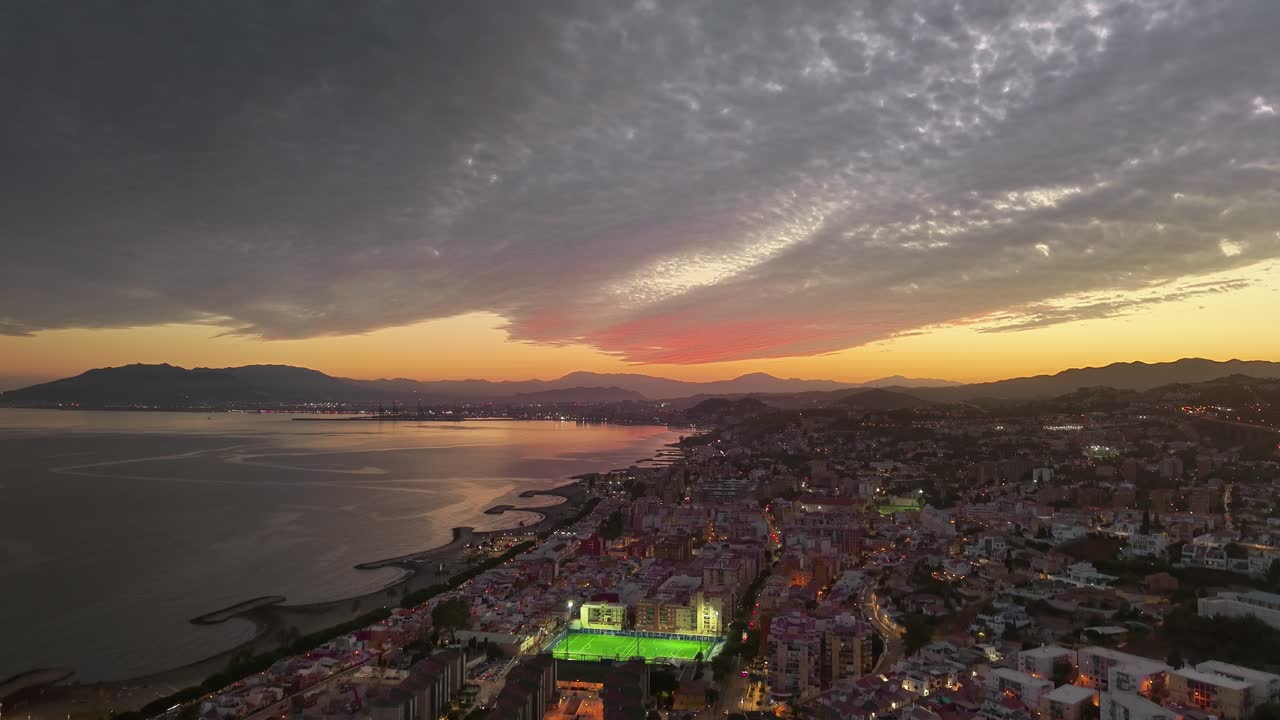 Sunset over the city of Malaga. Coast of the port city from a drone in southern Spain