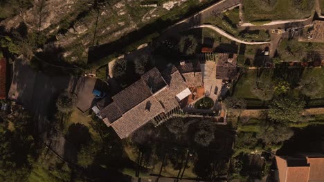 a luxurious house with a lush garden on the french riviera, bright sunlight, aerial view