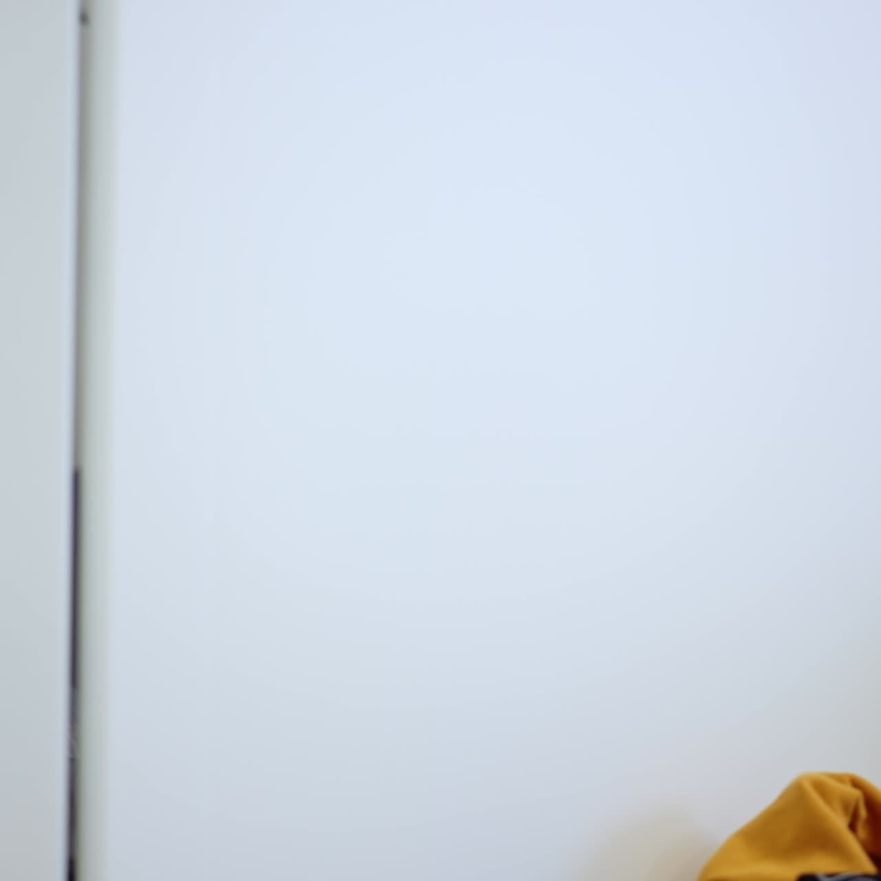 Curious toddler sitting on the floor at the closet. Baby pulls the door open looking inside