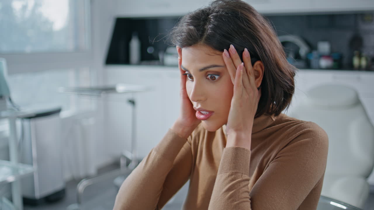 Woman experiencing headache, stress, and anxiety