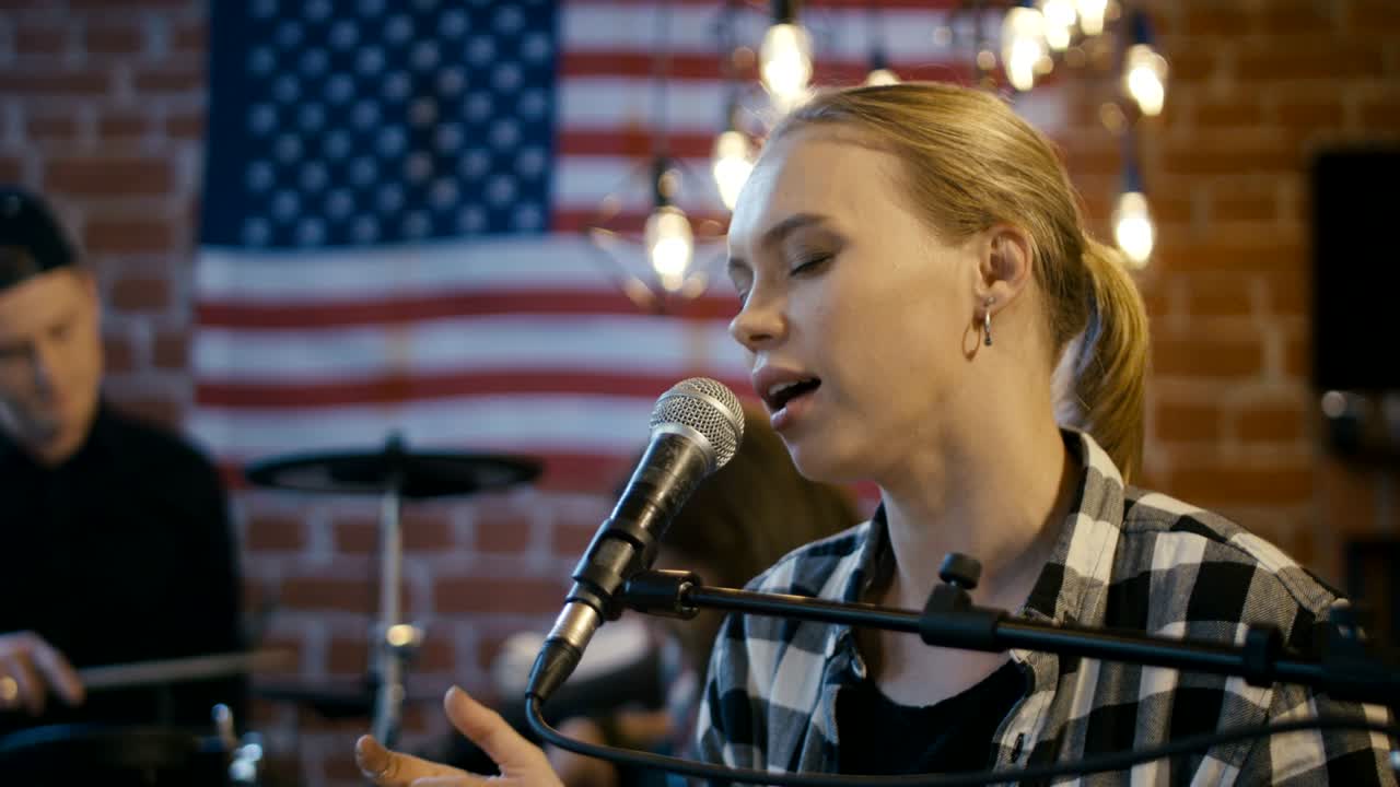 Beautiful blonde woman singing with feelings