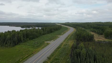 highway next to a lake in alaska