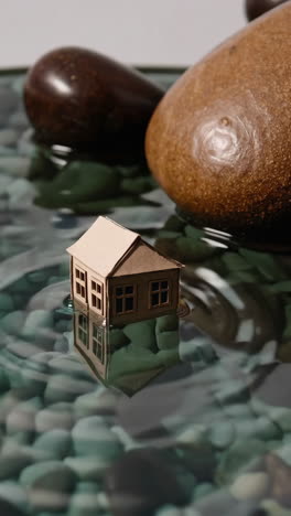 miniature paper house floating on water