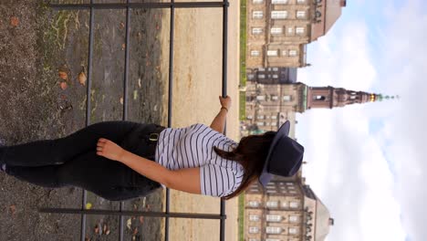 Female-tourist-looking-at-Christiansborg-Palace,-Copenhaguen,-Denmark