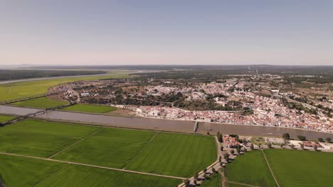 beautiful portugal town surrounded with green agriculture fields, high angle drone view