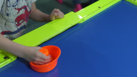 child playing air hockey