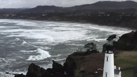 aerial view, yaquina lighthouse over north pacific ocean, cloudy overcast afternoon