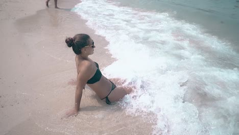 rolling-waves-wash-woman-body-with-white-thick-ocean-foam