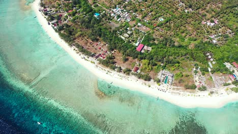 Exotic-beach-of-Philippine-tropical-island-with-white-sand,-surrounded-by-trees,-hotels-and-calm-lagoon-full-of-coral-reefs