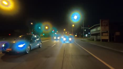 rear facing night driving point of view pov for interior car scene green screen replacement - rush hour evening traffic on a suburban dual lane road and stopping at traffic lights