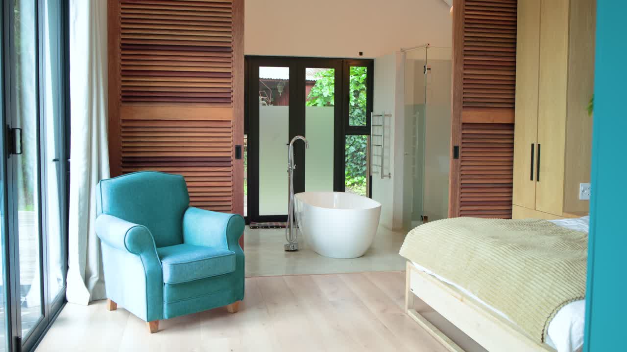 On sequence start, camera is panning right to reveal sliding glass door, freestanding bathtub
