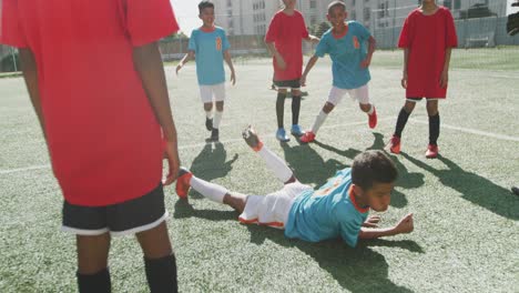 african american kid in blue scoring in a sunny day