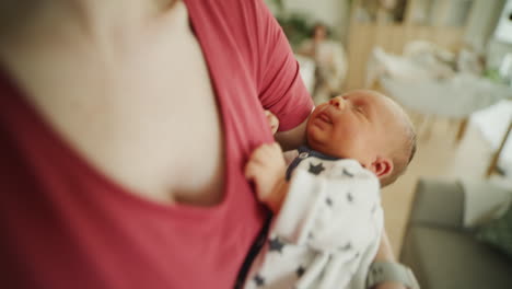 close-up of a newborn being cuddled by mother