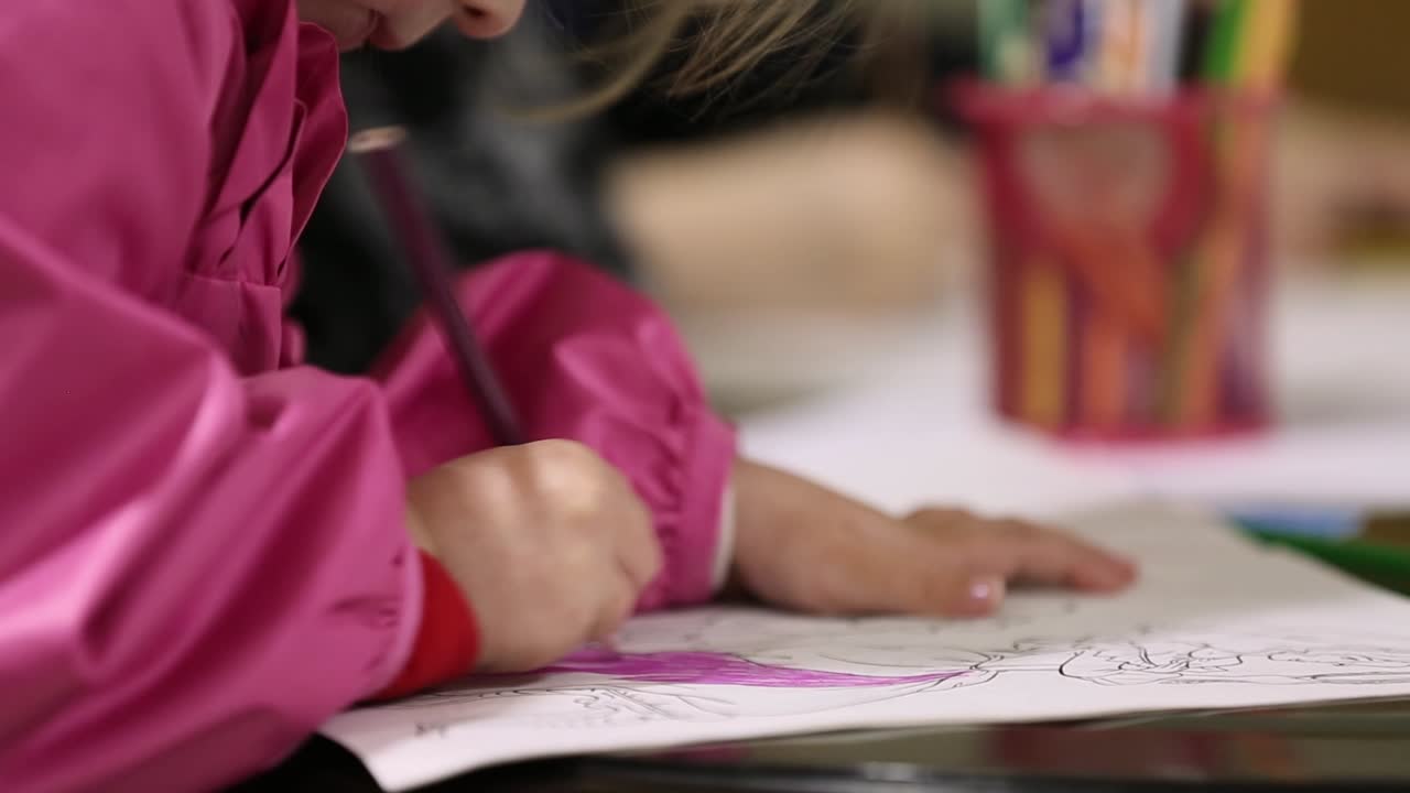 Child Drawing With Color Pencils. Happy young childrens drawing in kindergarten