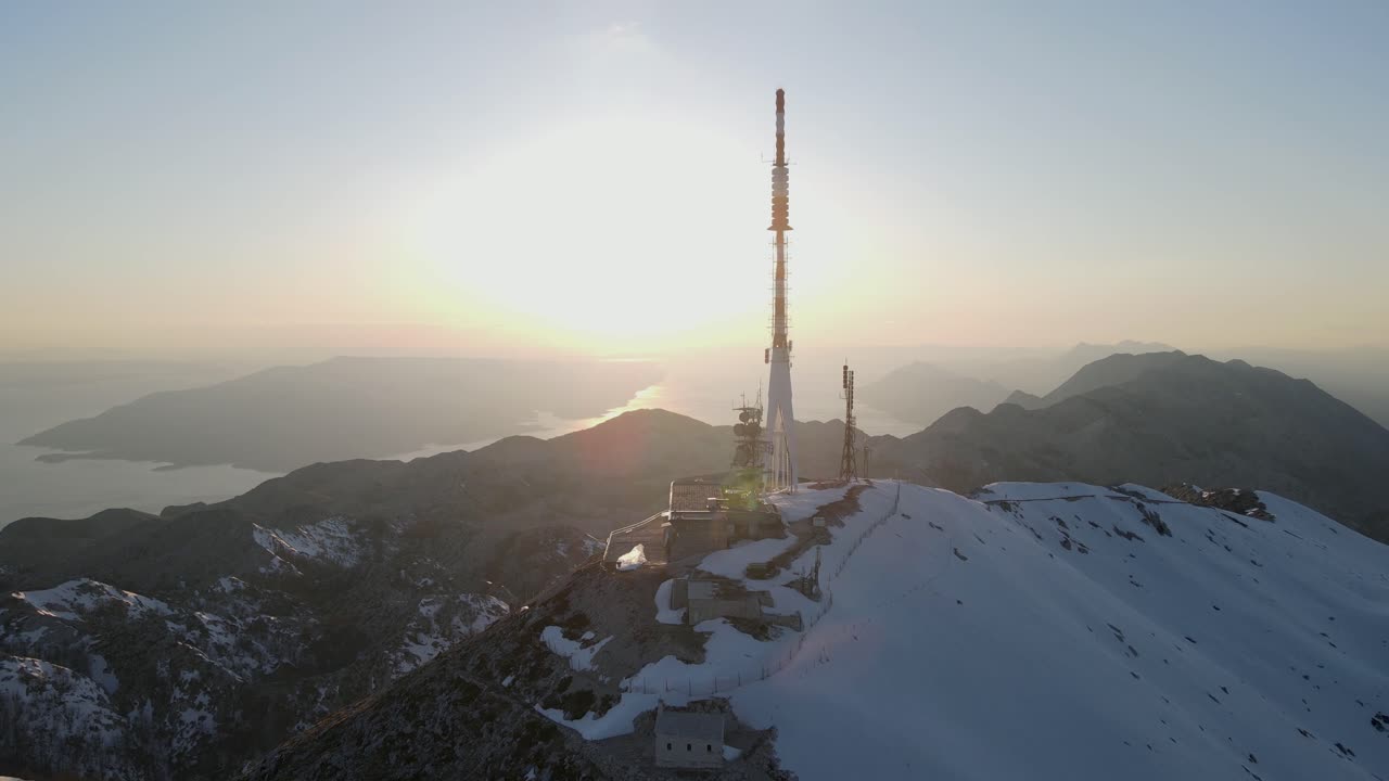 Tv tower on mountain peak against islands and fire sunset on Adriatic Sea.  Sveti Jure, Park prirode Biokovo.