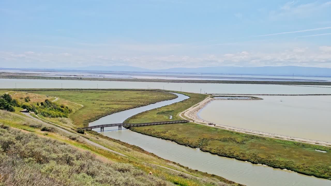 Panning view of coyote hills wetlands in Newark California some clouds and blue skies