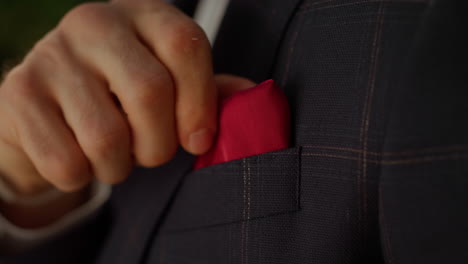 man hand getting better handkerchief in park. guy preparing for event outdoors