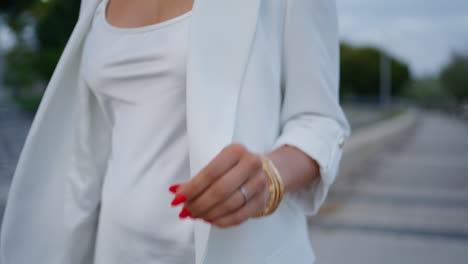 unknown girl going street in elegant white outfit close up. lady walking alley