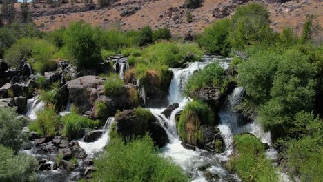 Multi-tiered-waterfall-in-desert-landscape