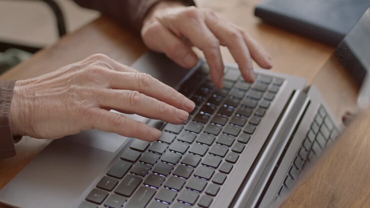 Senior Male Hands Typing on Laptop