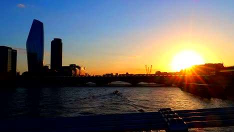 amazing golden hour view of thames river with small boats and london skyscrapers