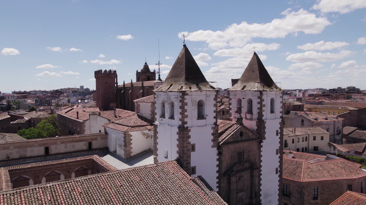 Aerial view orbiting C&aacute;ceres Iglesia de San Francisco Javier baroque catholic church whitewashed bell towers