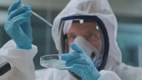 chemist-is-mixing-reagents-in-plate-in-laboratory-dropping-one-liquid-in-other-experiment-and-research-developing-of-new-drug