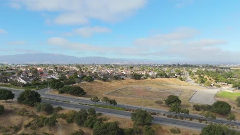 wide aerial of natividad creek park showing grass fields and walking trails on a sunny day, ascend overview