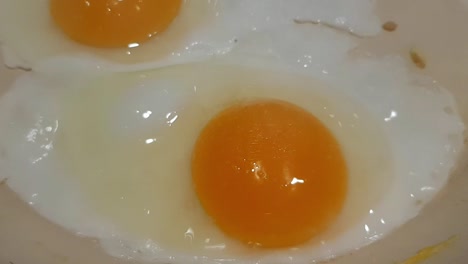 close up view of eggs being cooked in a pan