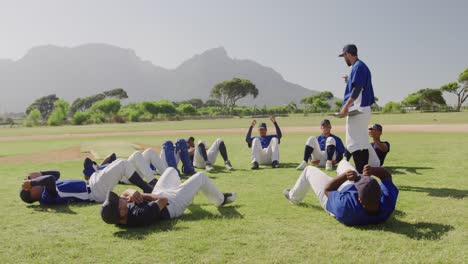 baseball players doing sit ups at a playing field