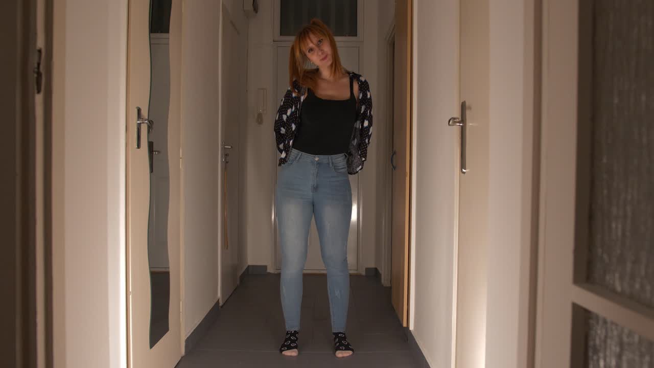 Beautiful sexy and creepy girl showing 2 swords in the dark hallway, full shot