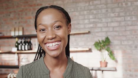 portrait of happy african american woman smiling, standing in coffee shop, copy space, slow motion