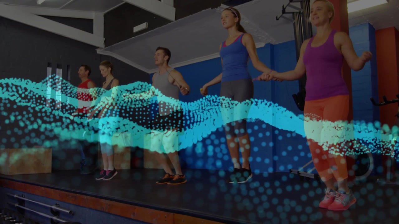 Five adults holding ropes skipping in sync, turquoise wave receding and revealing legs for fitness