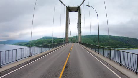 Driving a Car on a Road in Norway. Vehicle point-of-view driving over the bridge.