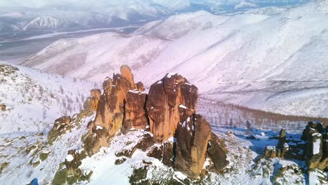 flying a drone over snowy cliffs in sunny weather 4k