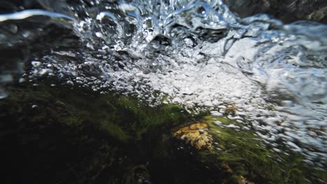 An-over-under-shot-of-the-fast-flowing-shallow-river