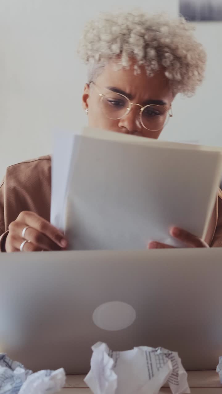 Young upset african american woman throws away documents read sits in office