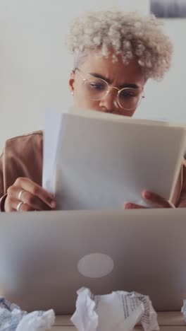 young upset african american woman throws away documents read sits in office