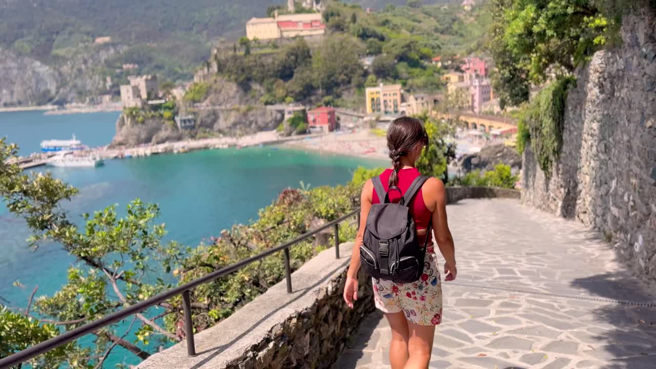 Young Woman Walking Through Picturesque Streets of Cinque Terre, Italy – Rear View in Colorful Mediterranean Village