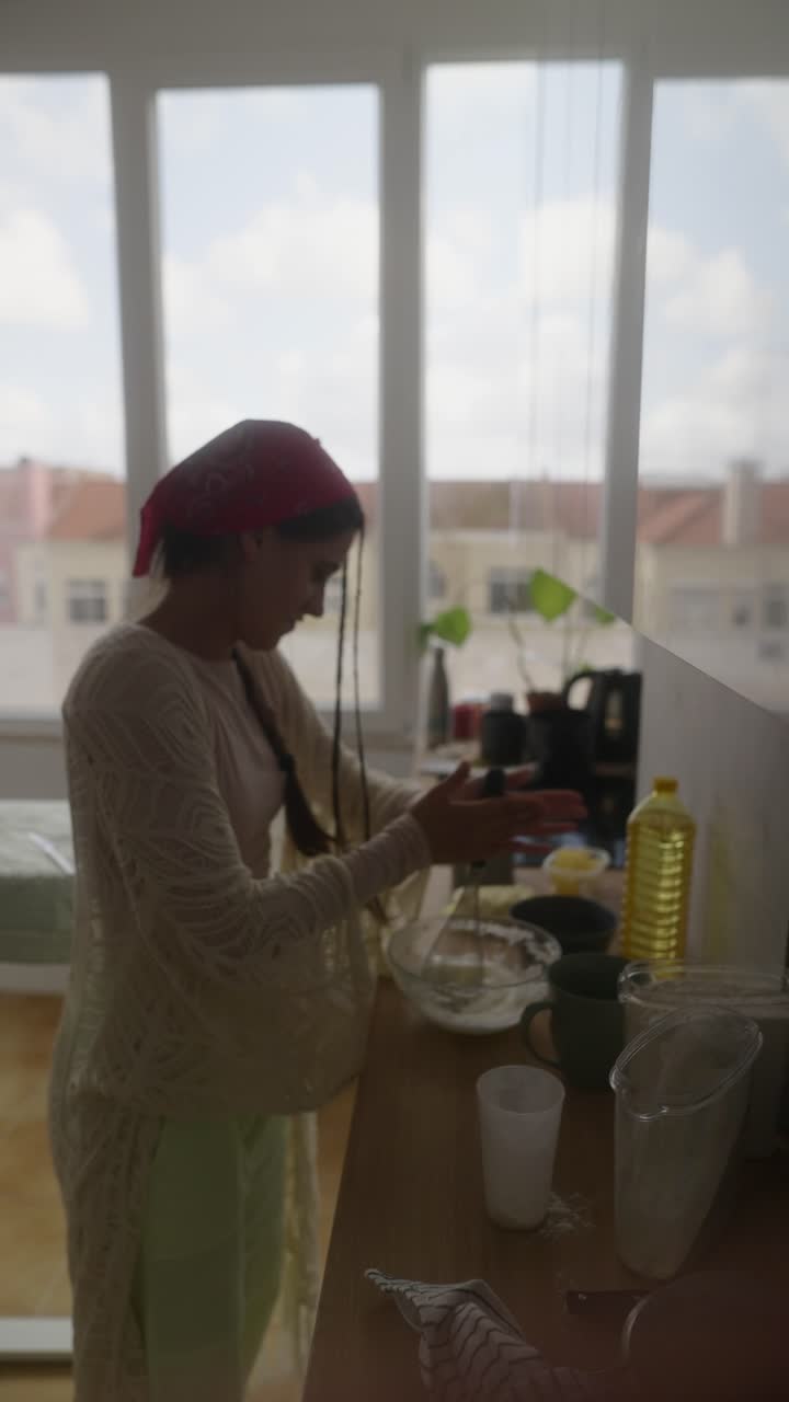 Woman Preparing a Dish in a Kitchen