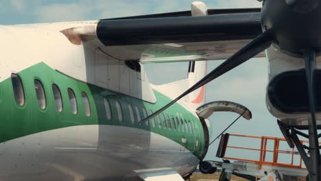 wing and engine view of air cote d'ivoire bombardier dhc-8 q400 airplane at abidjan félix houphouët-boigny international airport