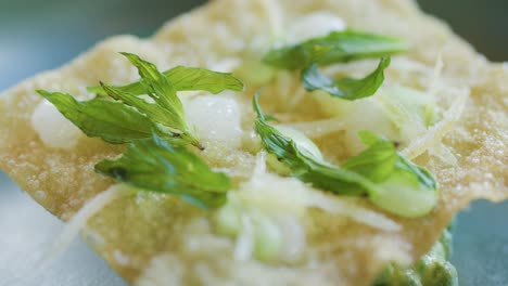 close-up macro sequence of a fork and knife cutting into a crisp seafood crab cake garnished with fresh herbs, under soft natural lighting