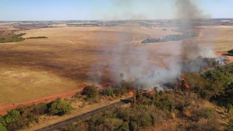 Aerial-view-of-bush-fire-beside-highway,-fire,-bush,-danger