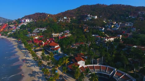 looking down on the busy city over a stadium, houses, and businesses in the gorgeous town along the west coast of mexico